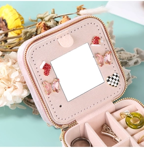 Pink velvet jewelry box detail with inner mirror and butterfly decorative charms