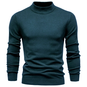 Macro view of the ribbed turtleneck and fine knit texture on a men's peacock blue sweater