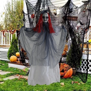 Close-up of hanging Halloween skeleton ghost with red hair and grey gauze robe