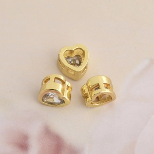 Three gold heart-shaped zircon beads with hollow mesh design for DIY jewelry making