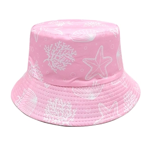 Detail of pink bucket hat featuring white starfish, coral, and seashell marine patterns