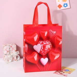 Close-up of red non-woven gift bag with 3D heart balloon print and glossy finish