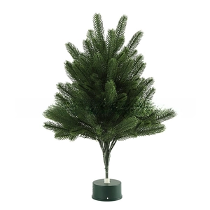 Close-up of deep green artificial needle Christmas tree branches on a round stand