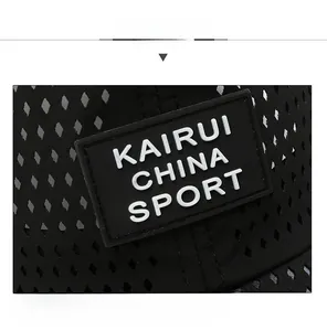 Detail of breathable mesh fabric and rubber logo patch on a black athletic cap