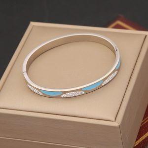 Detail of silver evil eye bracelet with turquoise enamel and white crystals on jewelry box