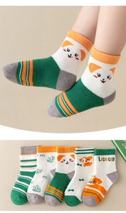 Close-up of assorted cartoon cotton socks for kids in green, orange, and white colors