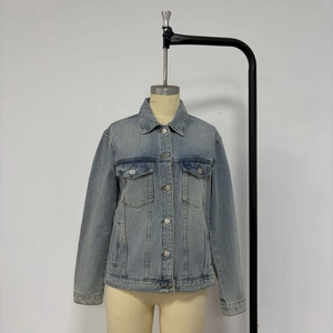 Detail of light blue denim jacket with vintage wash, cargo pockets, and classic turn-down collar