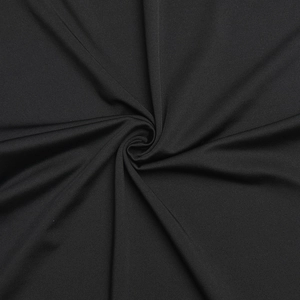 Detailed close-up of premium black knitted fabric showing fine texture and sleek finish