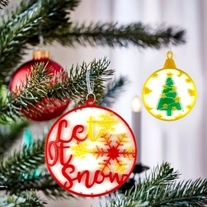 Christmas round resin mold ornaments with Let it snow and tree designs on a festive tree