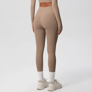Rear view of khaki high-waisted yoga leggings showing peach lift and seamless design