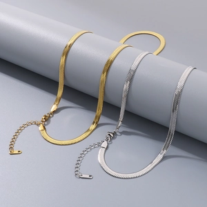 Macro detail of flat blade snake chain necklace with lobster clasp and extension chain
