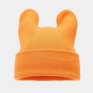 Detailed texture of vibrant orange knit beanie with cute animal ear design for winter
