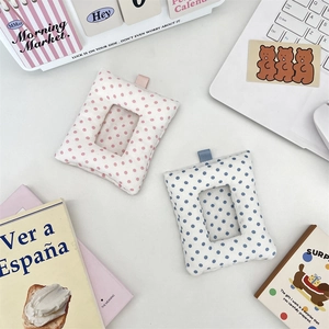 Detailed view of pink and blue polka dot fabric card holders with clear display windows