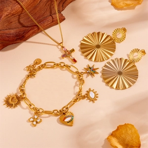 Detailed close-up of gold stainless steel devil's eye heart bracelet and star pendants