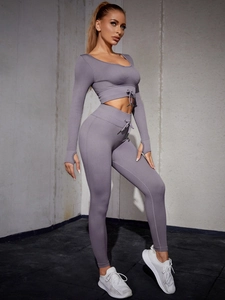 Detail of ribbed lavender workout set featuring drawstring crop top and high waist leggings