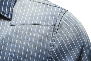 Detailed close-up of striped denim shirt showing washed texture and stitching