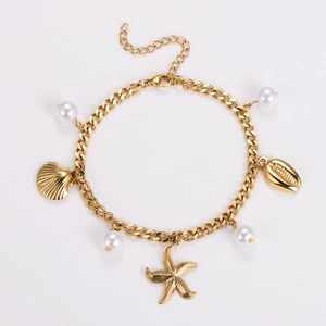 Detail of gold starfish and shell pendants with white pearls on a chain bracelet