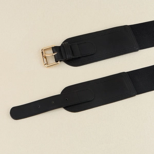 Elastic black wide waist belt featuring a premium leather front and gold needle buckle