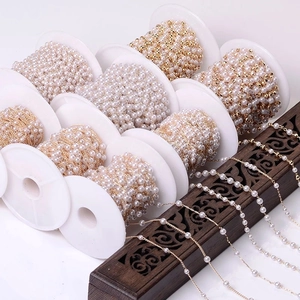 Roll of white faux pearl beads with gold wire chain for DIY jewelry making and crafts
