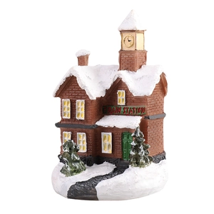Christmas train station miniature house with red brick walls and snow covered roof