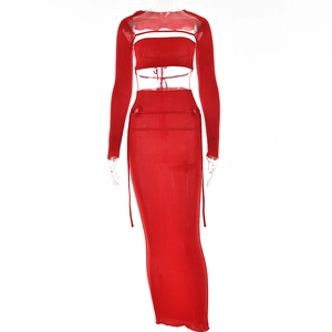 Detail of red two-piece set featuring long sleeve tube top and high waist long skirt
