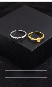 Detail of lava texture rings with starburst engraving in gold and silver finish