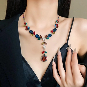 Close-up of elegant rhinestone zircon necklace with colorful leaf and teardrop pendants