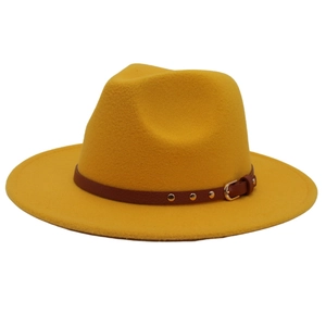 Close-up of ginger wool fedora hat featuring a brown leather strap and gold buckle detail