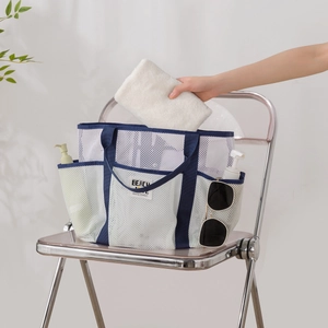 Large white mesh beach tote with navy blue trim and multi-pocket storage design