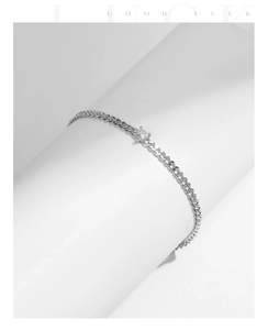Close-up of S925 sterling silver chain bracelet with a sparkling heart-shaped zircon