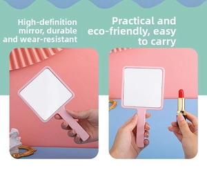 Close-up of pink square handheld mirror with handle showing scale next to lipstick