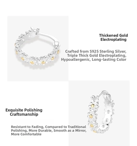 Detail view of S925 sterling silver daisy hoop earrings with gold-plated flower centers