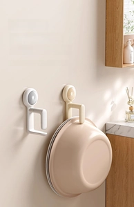 Rotating vacuum suction cup wall hook for washbasins in a modern bathroom setup