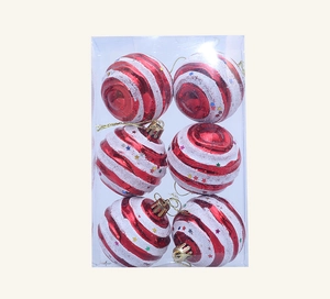 Detail of red and white striped Christmas ornaments with colorful stars in a set