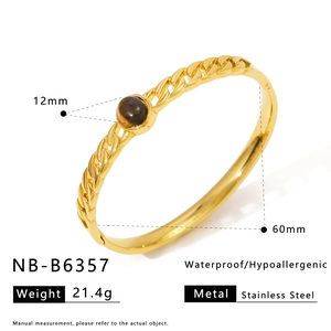 Detail of waterproof stainless steel gold bangle with 12mm brown gemstone inlay