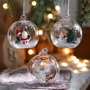Set of three decorative Christmas glass balls with Santa, Snowman and Reindeer figurines