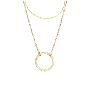Double layered gold stainless steel necklace with textured circular pendant on white background