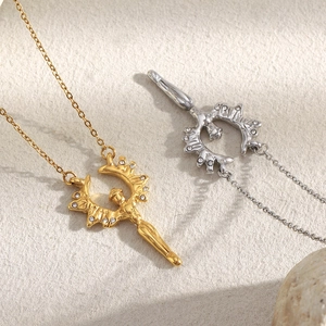 Gros plan détaillé de pendentifs anges en or et argent avec strass brillants sur chaînes