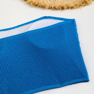 Detail of royal blue wave texture fabric and removable round chest pads on bikini top