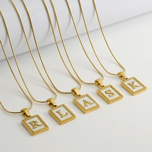 Five gold snake chains with square letter pendants R, L, A, S, K on white background