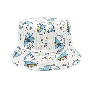 Close-up of kids bucket hat featuring cartoon shark prints and Nom Nom text details
