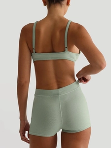 Detail shot of light green ribbed knit yoga set showing back fit and fabric texture