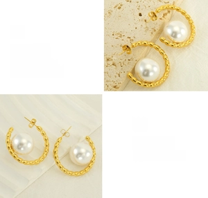 Detail of C-shaped gold pearl earrings showing textured metal and polished finish