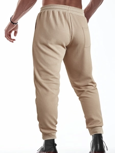 Close-up of khaki waffle knit texture on men's casual trousers with back pocket