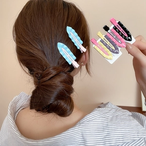 Detail of candy-colored wavy hair clips in diverse pastel shades on a display card