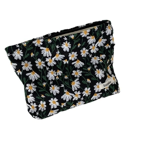 Black canvas cosmetic bag with white daisy embroidery and zipper closure for women
