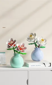 Close-up of decorative artificial lily and rose building block flowers with ceramic vases