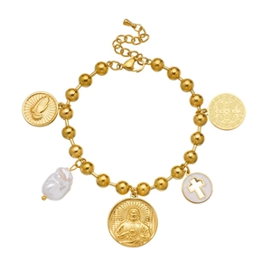 Gold beaded religious bracelet with baroque pearl and cross charms on white background