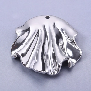 Detailed view of an irregular wavy silver stainless steel pendant with reflective finish