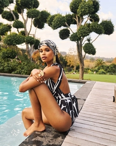 Detail of zebra stripe one-piece swimsuit with open back and matching headscarf